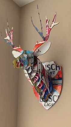 a deer head made out of magazines on the wall