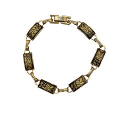 Vintage Damascene gold and black enamel bracelet has rectangle panels with flowers. Bracelet measures 7 inches length and has fold over clasp. Each panel measures ½ inch long.  Very nice condition. Please see photos for more details. All items are vintage that are preowned. All of the items may show some form of wear due to their age. Please kindly remember that these items are anywhere from 30-80 years old. I make every attempt to clearly describe the item, including any flaws or wear to the be Antique Gold Rectangular Bracelet, Vintage Black Enamel Rectangular Jewelry, Vintage Enamel Jewelry With Rectangular Shape, Vintage Rectangular Black Enamel Jewelry, Vintage Rectangular Enamel Jewelry, Rectangular Metal Bracelets Engraved, Formal Rectangular Gold Bracelet, Engraved Rectangular Gold Bracelet For Formal Occasions, Rectangular Engraved Gold Bracelet For Formal Events