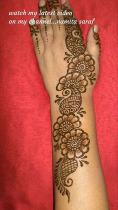 a woman's hand with henna tattoos on it