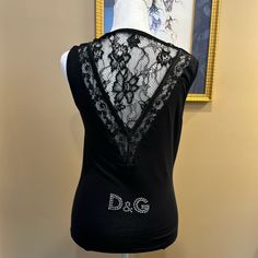 Gorgeous, Stretchy, Black Tank Top, With Lace Details And Rhinestone D&G On The Back. Tags Still Attached. Luxury Tops For Summer Night Out, Designer Black Embellished Tops, Designer Sleeveless Party Tops, Designer Black Tops For Night Out, Designer Black Sleeveless Top, Designer Sleeveless Tops For Evening, Tank Top With Lace, Black Tank Top, Black Tank