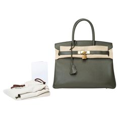 Splendid​ ​Hermes​ ​Birkin​ ​30​ ​handbag​ ​in​ ​Vert​ ​de​ ​Gris​ ​Epsom​ ​leather,​ ​gold​ ​plated​ ​metal​ ​trim​ ​,​ ​double​ ​handle​ ​in​ ​green​ ​leather​ ​allowing​ ​a​ ​hand​ ​carry Flap​ ​closure Green​ ​leather​ ​inner​ ​lining​ ​,​ ​a​ ​zippered​ ​pocket,​ ​a​ ​patch​ ​pocket Signature:​ ​"Hermès​ ​Paris​ ​Made​ ​in​ ​France" Stamp​ ​:​ ​Y​ ​(2020) Dimensions:​ ​30x22x15​ ​cm​ ​(11,8x8,7x5,9​ ​Inches) Reference:​ ​101534 General​ ​condition:​ ​8.5/10 Note​ ​the​ ​presence​ ​of​ ​plastics​ ​on​ ​the​ ​fittings Sold​ ​with​ ​copy​ ​of​ ​the​ ​original​ ​Hermès​ ​invoice,​ ​tirette,​ ​clochette,​ ​padlock,​ ​keys​ ​and​ ​dustbag In​ ​mint​ ​condition Option in addition: Certificate of authenticity issued by a judicial expert at the Appeal Court of Paris Luxury Leather Khaki Bags, Luxury Khaki Leather Bag, Luxury Khaki Rectangular Bag, Luxury Green Satchel With Leather Handles, Luxury Green Satchel With Double Handle, Luxury Green Satchel With Handles, Luxury Khaki Shoulder Bag For Travel, Green Satchel For Office Use, Green Satchel For Office