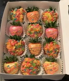 a box filled with lots of different types of fruit covered in frosting and sprinkles