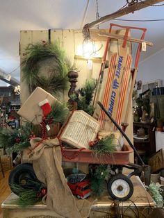 an assortment of christmas items on display in a room with wooden floors and ceilinging