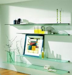 a living room filled with furniture next to a wall mounted shelf above a fire place