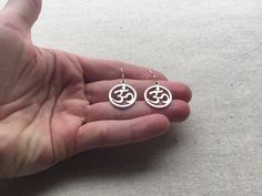 "Stunning silver Ohm round earrings. These are the perfect accessory for any yoga, meditation lover. Bring a little namaste into your life. Made from allergy free plated silver. They measure 5/8\" across by 3/4\" long and hang from simple silver ear wire hooks. I have a matching necklace in my Etsy shop. Here is the link https://etsy.me/2VBdAv9 Thanks for stopping by! Please take a moment and visit the rest of my Etsy shop. I have many more unique and stylish jewelry to choose from. 🌸 Tiger Flo Symbolic Round Earrings For Pierced Ears, Symbolic Round Metal Earrings, Silver Symbolic Hypoallergenic Earrings, Silver Hypoallergenic Symbolic Earrings, Nickel-free Symbolic Round Earrings, Symbolic Nickel-free Round Earrings, Symbolic Round Nickel-free Earrings, Pierced Symbolic Round Earrings, Symbolic Round Pierced Earrings