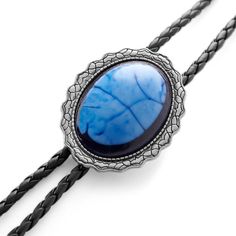 Deciding to wear a bolo tie is not the time to look for something small. It’s a statement-making accessory… so make one. This selection has a lot to say. Complete with a large blue stone in the silver-tone slide and faux leather cord. Feather-shaped metal tips finish the conversation-starting look. Easy to adjust with a Bennett-style clasp. Due to the natural origin of the stone, slight variations in colour and pattern may occur. Doc Holliday, Cheap Accessories, Bolo Tie, Tie Colors, Black Stone, Braided Leather, Gift Accessories, Blue Stone, Necktie