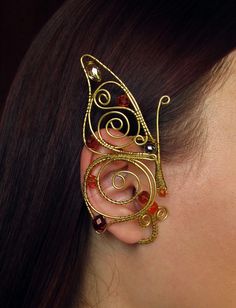 a close up of a person wearing some kind of ear piece with beads on it