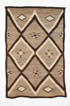 a brown and white rug with diamonds on it