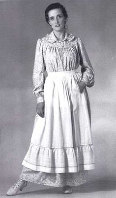 Sizes XS-3XL The stalwart women who braved the 19th century American prairie wore full yet practical housedresses of washable cotton. This flowing dress was traditionally worn with a practical apron. Ours falls to the ankles in voluminous gathers from a gracefully rounded yoke. It has long sleeves gathered at the shoulders and into buttoned cuffs. The ruffled collar is set into a collar band, and the dress has pockets set into both side seams. The deep front opening typical of this era closes wi Prairie Dress Pattern, American Prairie, Pioneer Clothing, Pioneer Dress, 1800's Dress, Pinafore Pattern, Prairie Dresses, Apron Sewing Pattern, Costume Sewing Patterns