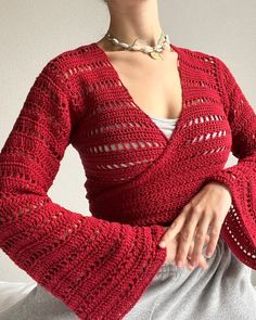 a woman wearing a red knitted sweater