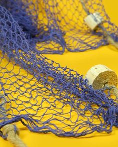 two corks in a blue net on a yellow surface