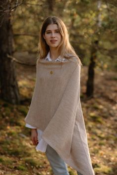 This hand knitted cape feels like warm and cosy hug. Soft merino, alpaca and mohair wool blend will keep body in perfect temperature. Due to natural wool advantages this pullover blanket sweater is ideal for all seasons. Hand knitted women's poncho is great for long walks in the forest, outdoor activity and resting at home. It's so versatily because you can wear it as a sweater on the top of other layers or on the jacket, even coat.  Oversized knit poncho could be amazing Christmas gift! One size knitted wool poncho fits most sizes. Please contact me if you need special one. Composition: 40% merino wool, 30% alpaca wool, 30% mohair wool Lady in the picture is 180 cm / 5.7 feet height Care instructions:  * Hand wash, 30 degrees C (85 degrees F) * Dry flat * Iron low heat * Do not bleach * D Cozy Cashmere Cape, Beige Alpaca Shawl For Fall, Fall Beige Alpaca Shawl, Winter Alpaca Cape Poncho, Cozy Wool Poncho Cape, Winter Alpaca Poncho Cape, Cozy Alpaca Cape For Winter, Cozy Alpaca Poncho For Winter, Cozy Cashmere Poncho For Winter