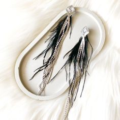 Our Feather & Rhinestone Duster Earrings are luxurious, long length, statement making earrings that feature a fanning style of feathers alongside iridescent toned rhinestone chains. These glamorous earrings will add a festive vibe to your winter party outfit! About 7 inches long Shape and colors will vary slightly This is a special occasion item, and therefore it is FINAL SALE Glamorous Earrings, Winter Party Outfit, Duster Earrings, Making Earrings, Winter Party, Long Length, 2 Colours, Tassel Necklace, Party Outfit