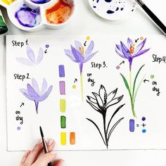 someone is painting flowers with watercolors on paper