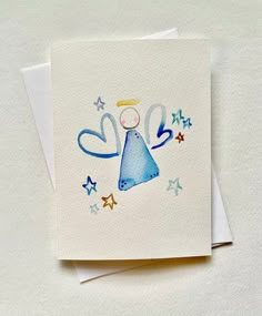 a card with an angel holding a ball on it's back and stars around it