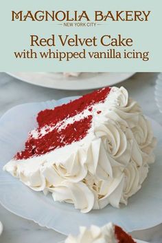 a red velvet cake with whipped vanilla icing on a white plate and in the background there is an advertisement for magnolia bakery