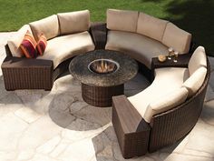 a fire pit surrounded by wicker furniture