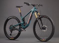 a blue and yellow mountain bike on a gray background