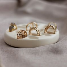 five different types of rings sitting on a white plate