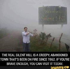 a man standing in front of a sign on top of a foggy hill with the caption that reads, the real silent hills is creepy abandoned town that's been on fire since 1932