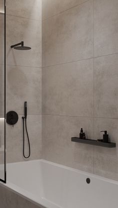 a bathroom with a bathtub, shower head and hand held shower faucet