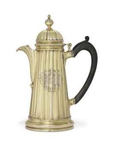 a gold and black coffee pot on a white background