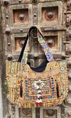 About bag  Indo-gypsy fusion, everyday use hand bag made from Banjara fabrics sourced from Vintage tribal costumes of regions of Rajastan and Gujarat. These are embellished with light catching coins, and intricate bead work tassels. Company details:  Company name: Houseoftextile  Contact number: +919784447473  Email id: houseoftextile77@gmail.com  Shipping & custom : Delivery through one of the finest service providers : Skyway, Fedex, UPS  And DHL. Any local taxes\custom has to be paid by clien Festive Rectangular Bag With Mirror Work, Bohemian Multicolor Bags With Zari Work, Bohemian Multicolor Zari Work Bag, Bohemian Shoulder Bag With Zari Work For Festive Occasions, Bollywood Bags With Mirror Work For Festivals, Bollywood Style Bags With Mirror Work For Festivals, Bollywood Style Festival Bags With Mirror Work, Traditional Embellished Multicolor Bags, Festive Bag With Mirror Work For Festivals