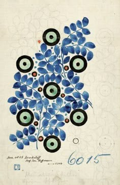 an old book with blue flowers and circles on the cover, in front of a white background