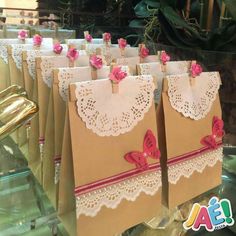 small brown bags with pink flowers and butterflies on them are lined up in a row