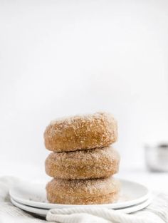 three sugar donuts stacked on top of each other