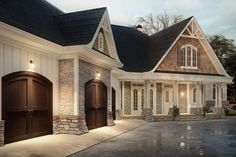 a large white house with two brown garage doors