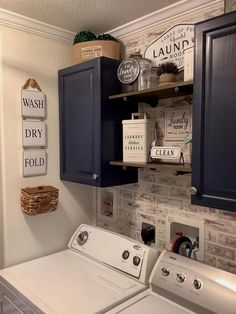 a washer and dryer in a laundry room next to cabinets with signs on them