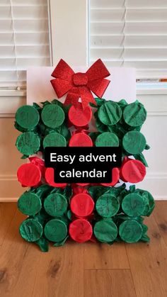 a christmas wreath made out of paper with the words easy advent calendar written on it