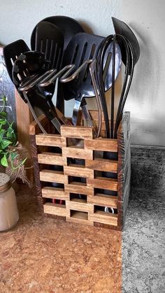 a wooden crate filled with utensils on top of a counter