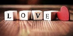 the word love spelled with cubes in front of a red heart