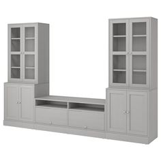 an entertainment center with glass doors and shelves