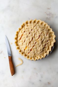 a pie sitting on top of a white table next to a knife and fork with an instagram message above it