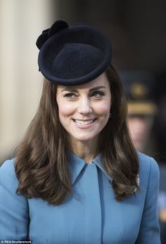 a woman wearing a blue coat and hat