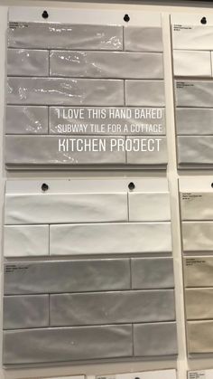 some white and gray tiles with words on them