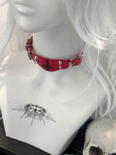 This red choker features a decorative inverted cross pendant adorned with studs. Add a touch of edgy style to your look with this statement piece. Perfect for adding a bold and unique touch to any outfit, this choker is a must-have accessory for those who love to stand out. Made with high-quality materials, it is both durable and eye-catching. Ideal for those who love to express their individuality through fashion.  The price is for a choker only, others are not included. Punk Choker For Halloween Festival, Punk Halloween Festival Choker, Grunge Choker For Cosplay, Alternative Style Choker For Cosplay, Red Punk Choker For Festivals, Emo Choker For Alternative Fashion, Red Emo Choker Jewelry, Red Gothic Choker For Festivals, Red Emo Style Choker Jewelry