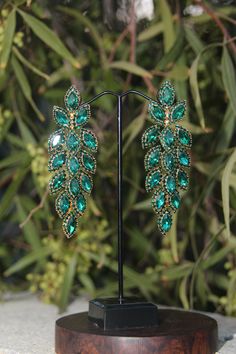 Green Crystal Chandelier Earrings For Party, Glamorous Green Chandelier Earrings For Wedding, Glamorous Green Chandelier Earrings For Evening, Green Chandelier Earrings For Evening, Green Emerald Dangle Chandelier Earrings, Glamorous Green Dangle Chandelier Earrings, Glamorous Green Jewelry With Rhinestones, Green Crystal Drop Earrings, Green Dangle Crystal Earrings For Party