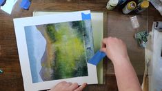 someone is painting an abstract landscape with watercolors