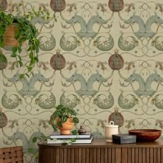 a room with a plant and wallpaper on the wall next to a wooden table