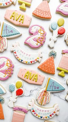 decorated cookies are displayed on a marble countertop with the words ava spelled in large letters