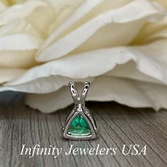 "The pendant pictured is a lab created emerald #6074 -Approximate total carat weight: approx. 1.80ctw diamond equivalent -Center Stone Size: 7x7mm - approx. 1.80ct diamond equivalent -Center Stone Shape: trillion -Gem Type: lab created emerald -Stone Clarity: VS2 -Stone Color: green -Moh's Scale: 8.5 hardness -Metal Type and Purity: 14k white gold -Setting: 3 prong basket head open back design -Chain: delicate 14k gold chain / heavier option with lobster claw available (use dropdown to select) - Gift Pear-shaped Brilliant Cut Emerald Necklace, Pear-shaped Brilliant Cut Emerald Necklace Gift, Emerald Jewelry With Trillion Brilliant Cut, Trillion Cut Brilliant Emerald Jewelry, Formal Trillion-cut Emerald Jewelry, Silver Pear-shaped Emerald Necklace For Anniversary, Trillion Cut Emerald Jewelry In Green, Anniversary Brilliant Cut Emerald Necklace In Sterling Silver, Trillion Cut Green Emerald Jewelry