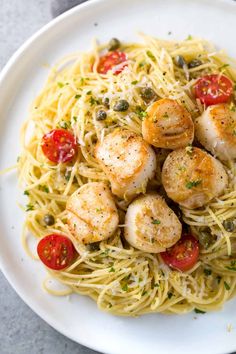 pasta with shrimp and tomatoes on a white plate