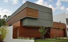 a modern house with wood slats on the side