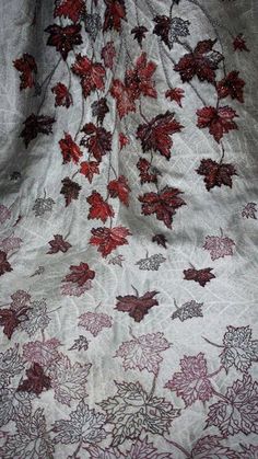 a white sheet with red leaves on it