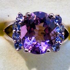 Genuine Amethyst And Tanzanite Sterling Silver Ring 5.14 Total Carats Stamped 925 Size 7 New In Box, Never Worn. This Ring Is Stunning! Sparkling And Huge Amethyst Center Stone, Flanked By Eight Shimmering Tanzanites, Set In A Shiny Sterling Silver Ring. Whether This Is A Gift For Yourself Or Someone Else, It Will Not Disappoint With Its Lavish Appearance! Very Impressive Piece To Add To Any Jewelry Collection! ****Open To Reasonable Offers**** #Mothersday #Birthday #Christmas #Valentine'sday #B White Gold Amethyst Ring With Gemstone Accents, Round Amethyst Gemstones For Formal Occasions, Round Amethyst Gemstones With Accents, Formal Multi-stone Amethyst Ring With Round Cut, Formal Purple Sapphire Ring With Gemstone Accents, White Gold Multi-stone Amethyst Ring, Purple Multi-stone Jewelry For Formal Occasions, Formal Purple Multi-stone Amethyst Ring, Formal Purple Multi-stone Jewelry