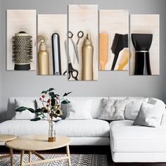 a living room with white furniture and art on the wall